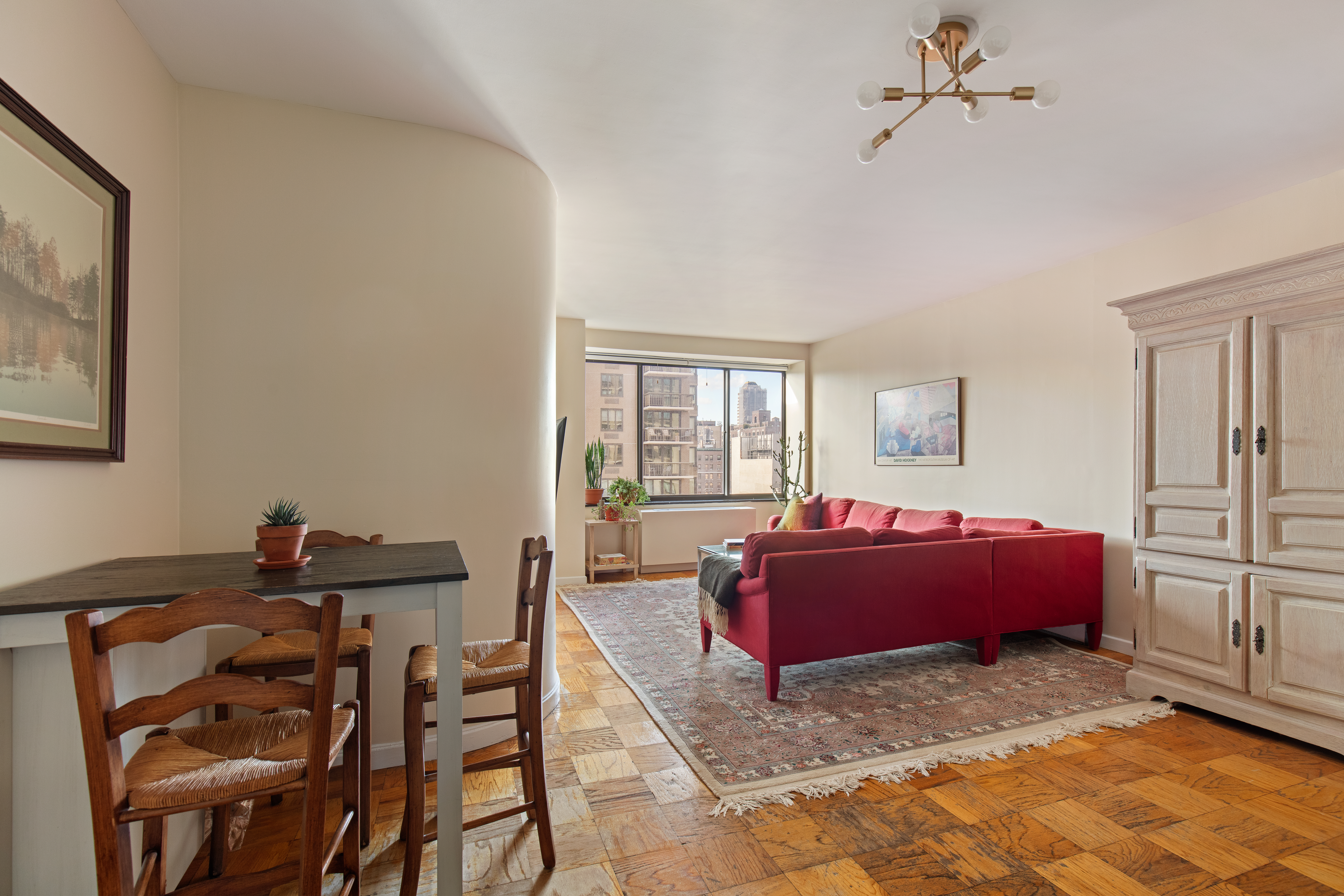 1441 3rd Avenue, Unit 14AB Manhattan, NY 10028 - Photo 10 of 16 a living room with furniture gym equipment and a window