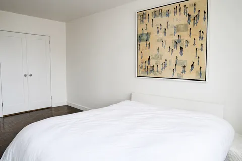 a large white bed in a white room