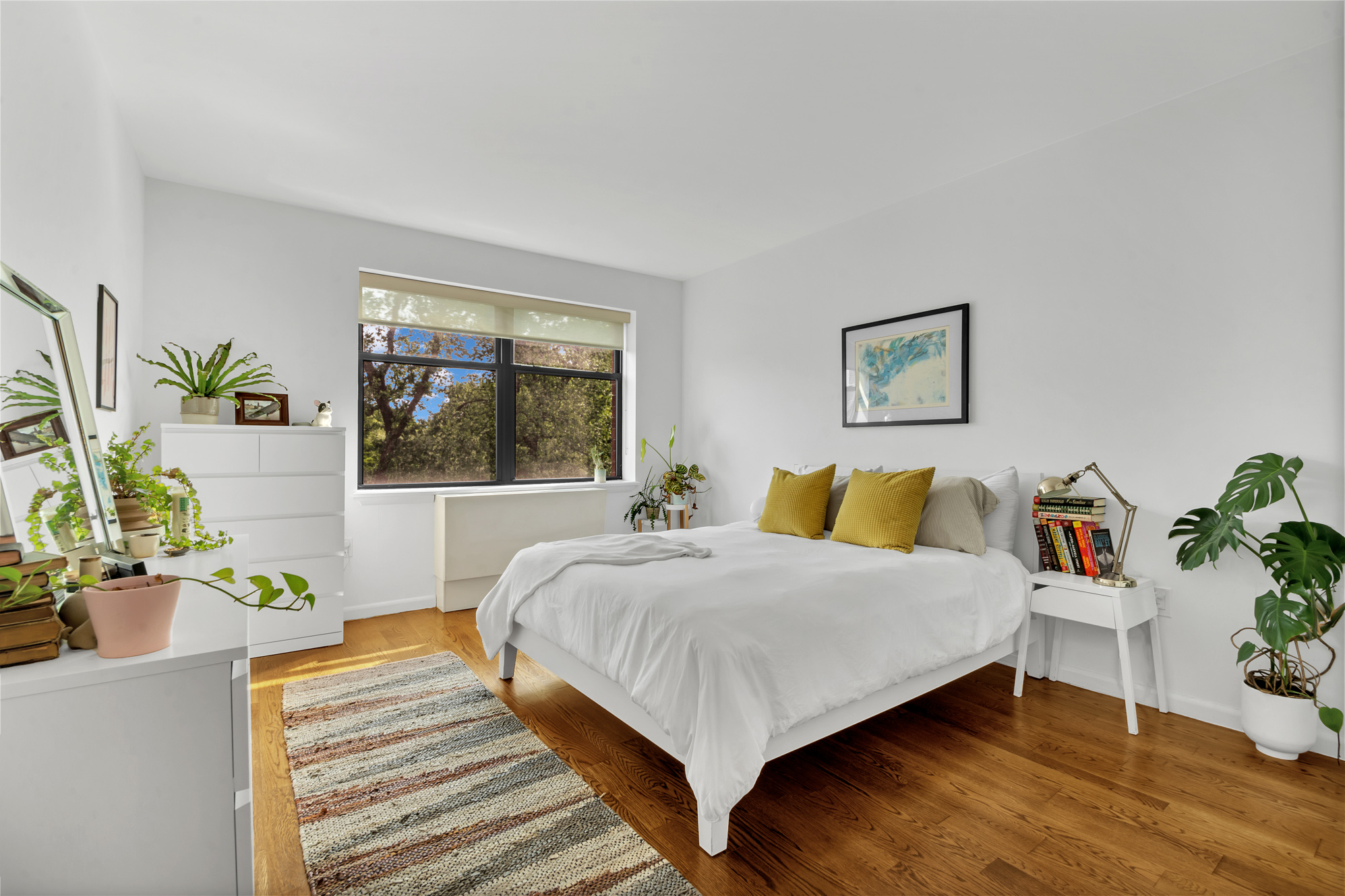 2002 5th Avenue, Unit 5B Manhattan, NY 10035 - Photo 6 of 7 a bedroom with a bed and a potted plant