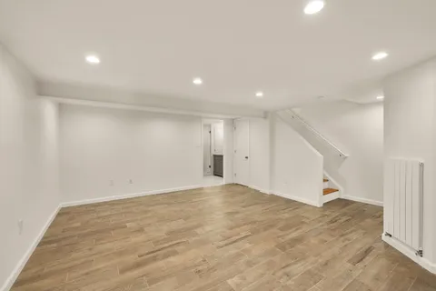 an empty room with staircase and white walls