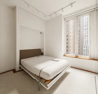 a view of a room with window and a ceiling fan