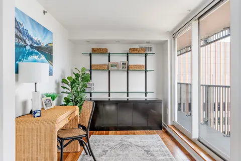 a living room filled with furniture and a potted plant