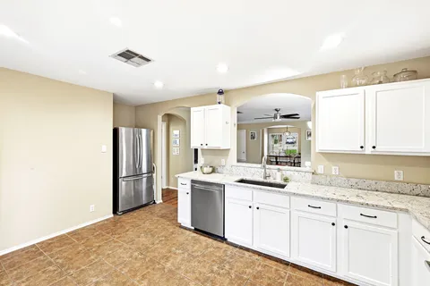 a kitchen with a sink stove and refrigerator