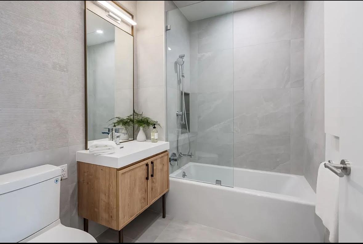 69 Adams Street, Unit 20A Brooklyn, NY 11201 - Photo 6 of 14 a bathroom with a sink a toilet and shower