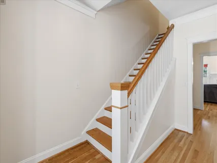 a spacious bedroom with a bed a dresser and a large window