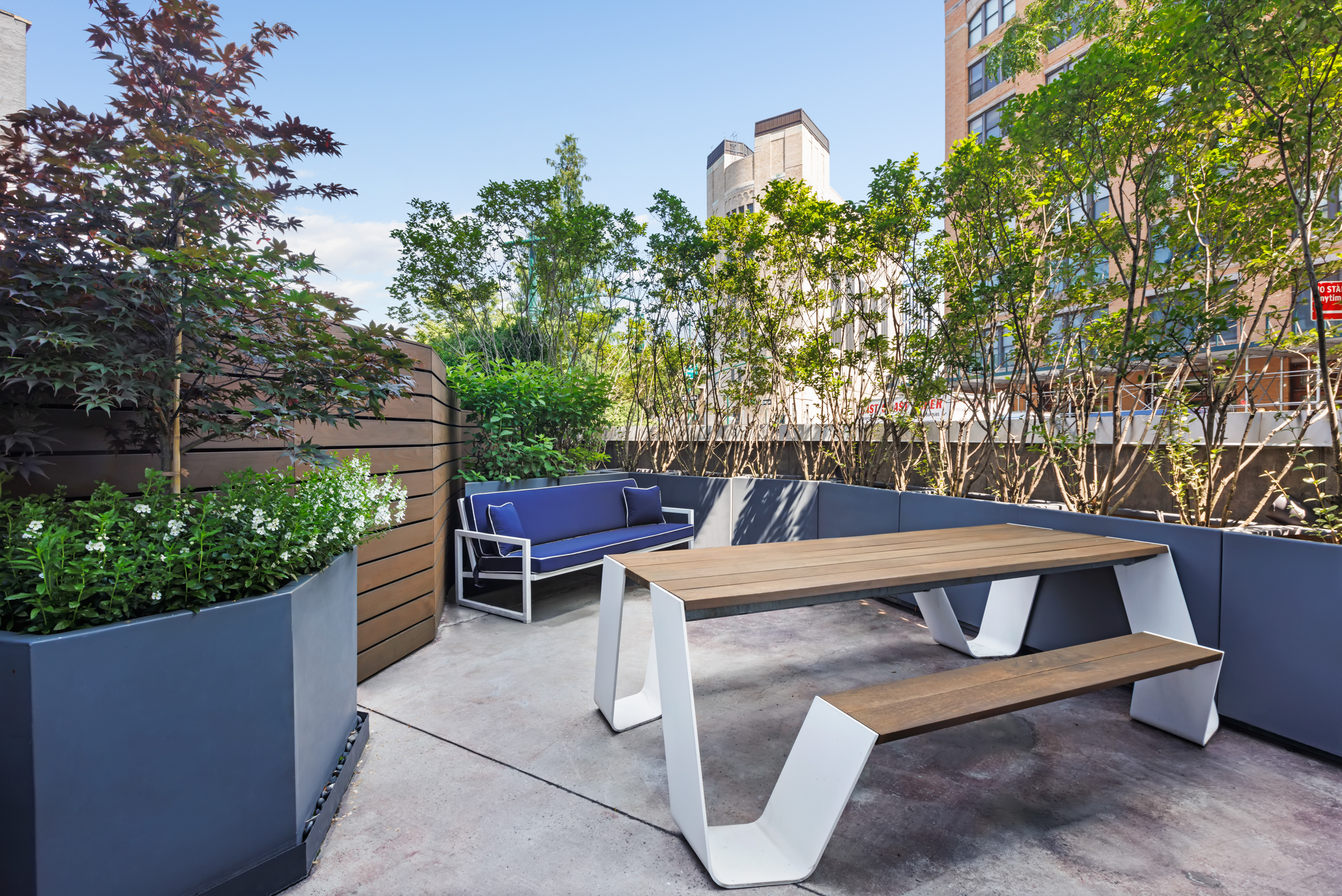 471 Washington Street, Unit 1B Manhattan, NY 10013 - Photo 3 of 17 a view of a patio with table and chairs potted plants and large tree