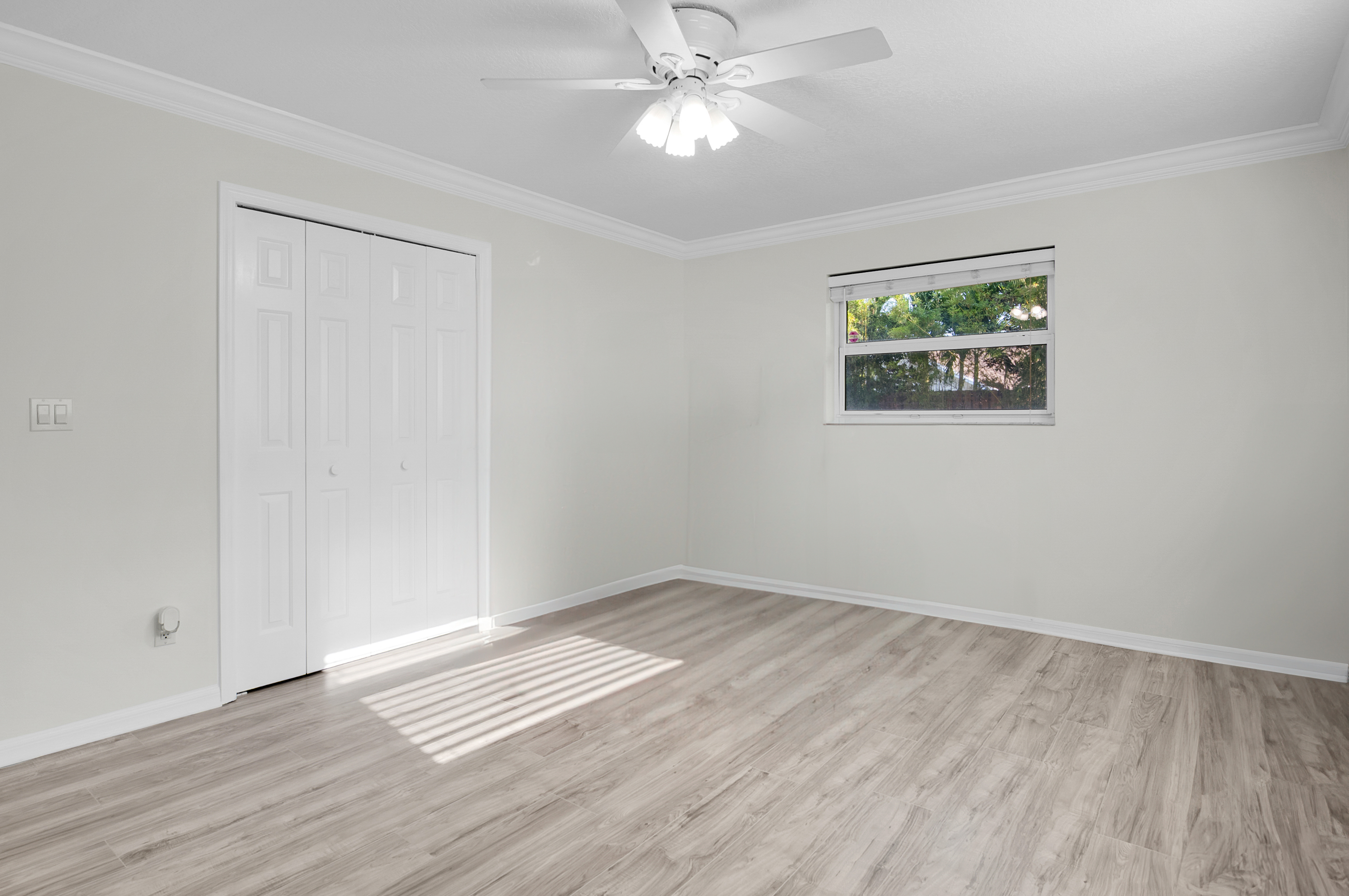 1560 Southwest 16th Street Boca Raton, FL 33486 - Photo 64 of 72 an empty room with wooden floor ceiling fan and windows