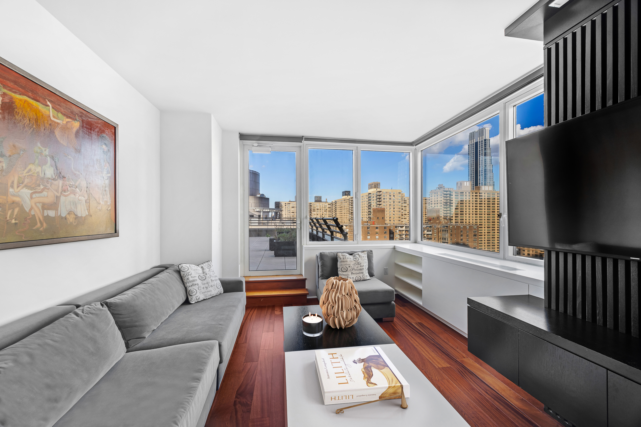 100 Riverside Boulevard, Unit 21A Manhattan, NY 10069 - Photo 5 of 22 a living room with furniture and a flat screen tv