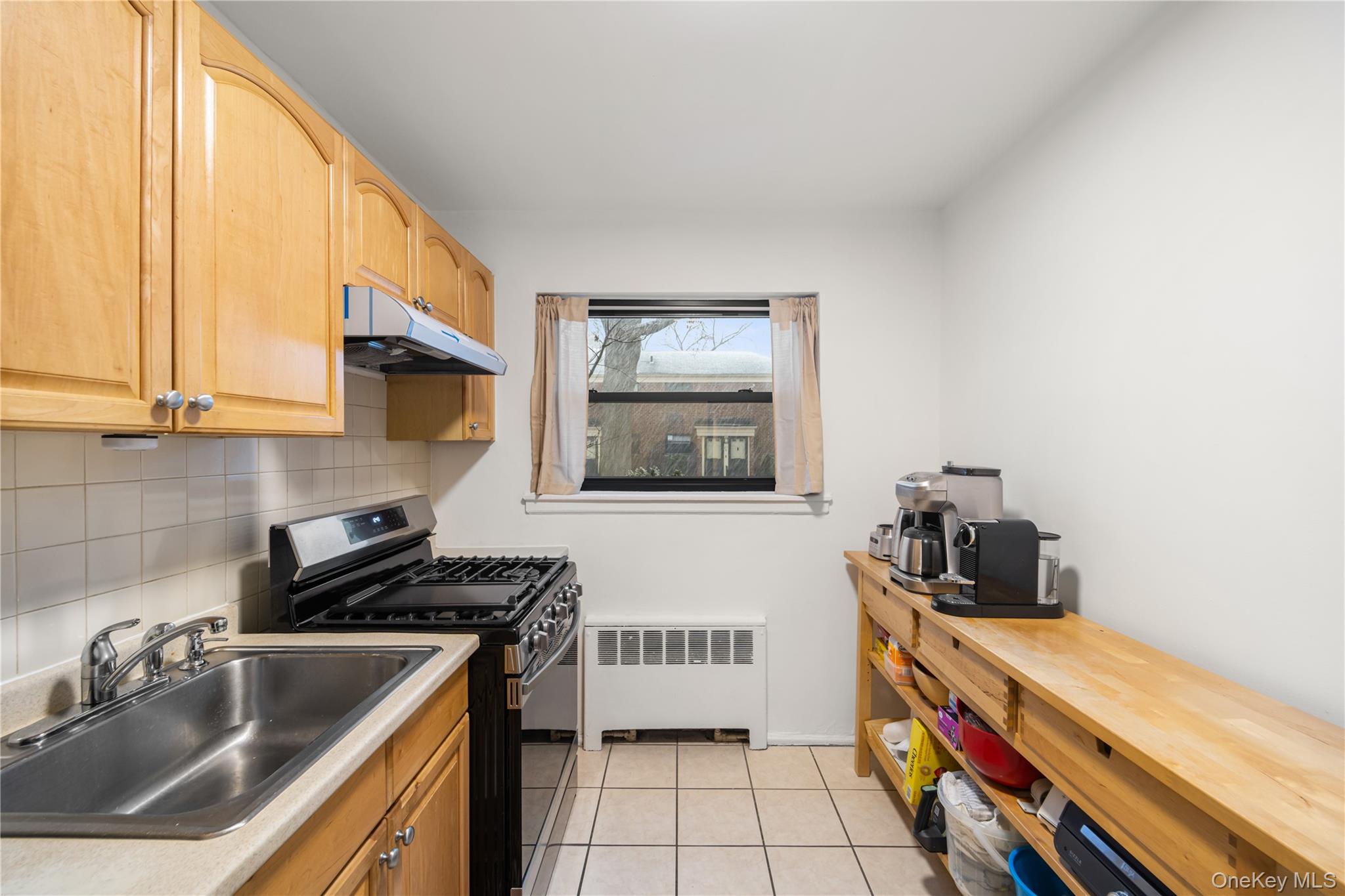 217-14 73rd Avenue, Unit 1 Queens, NY 11364 - Photo 18 of 19 a kitchen that has a sink and a stove