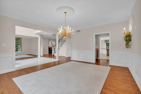 a view of a room with wooden floor and windows