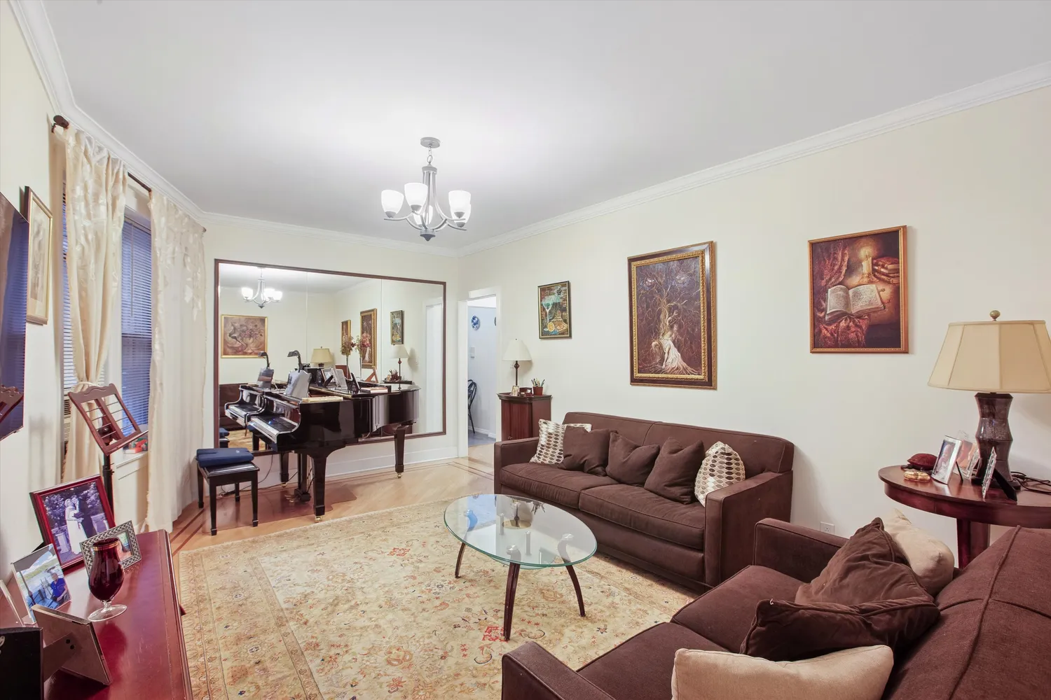 a living room with furniture dining area and a chandelier