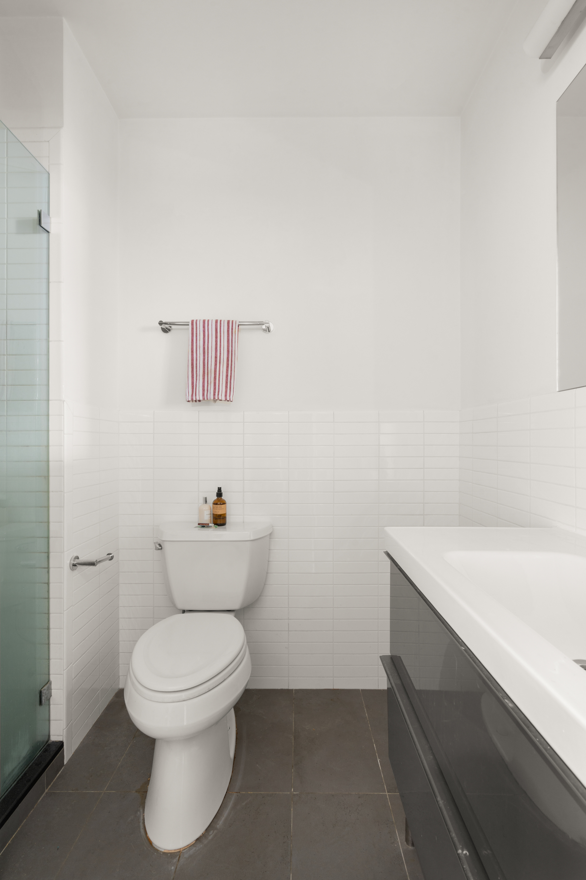 721 Metropolitan Avenue, Unit 4L Brooklyn, NY 11211 - Photo 6 of 7 a white toilet sitting next to a white sink