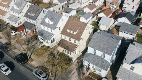 an aerial view of a residential apartment building with a yard