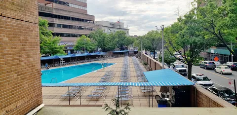 a view of a swimming pool with seating area