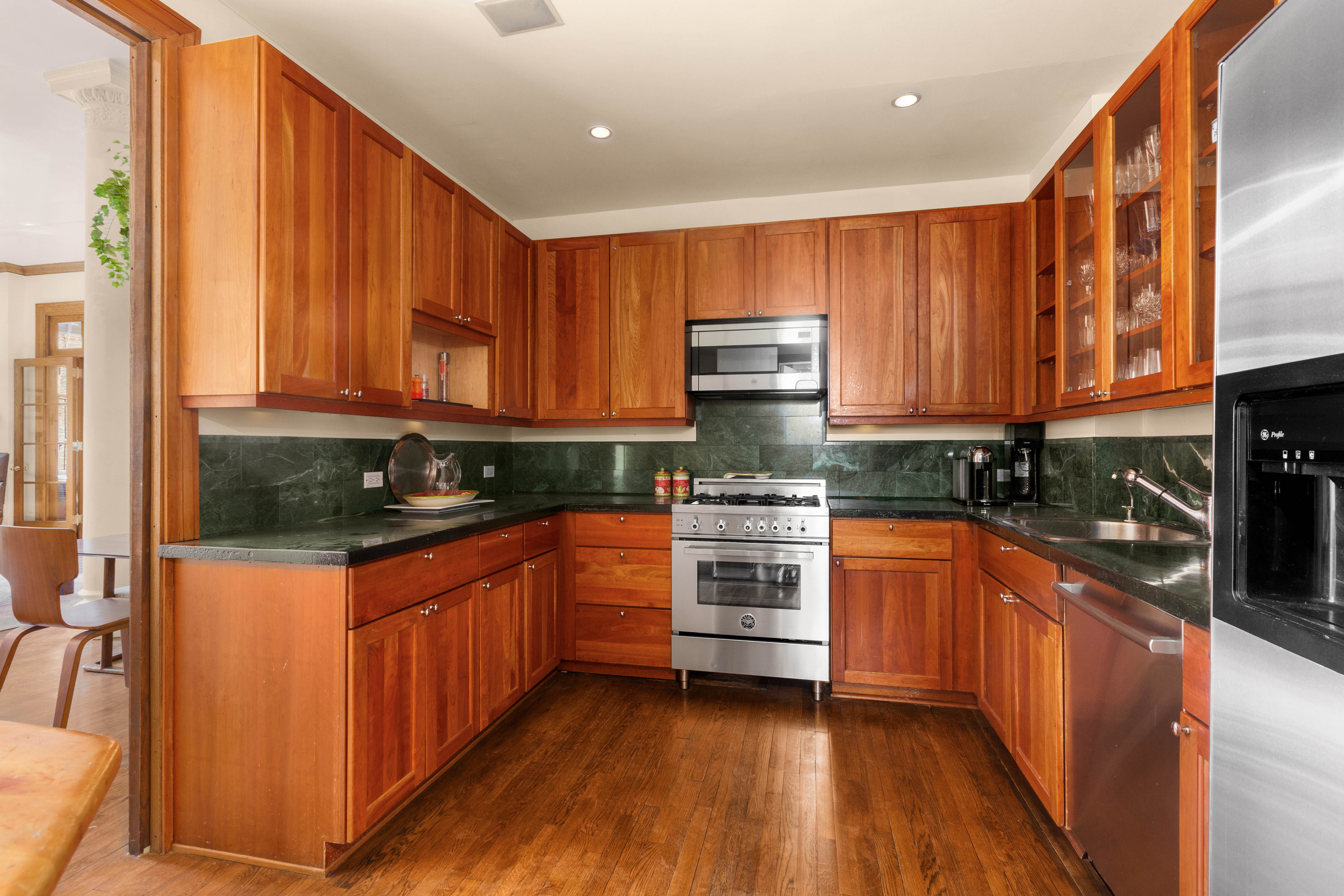 30 East 21st Street, Unit 6B Manhattan, NY 10010 - Photo 6 of 16 a kitchen with stainless steel appliances granite countertop a stove a sink and a refrigerator