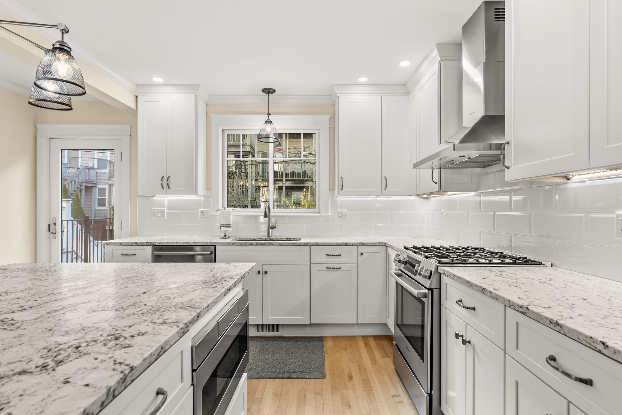 367 Silver Street South Boston, MA 02127 - Photo 3 of 9 a kitchen with granite countertop a sink stove and cabinets