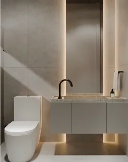 a white toilet sitting next to a bathroom sink
