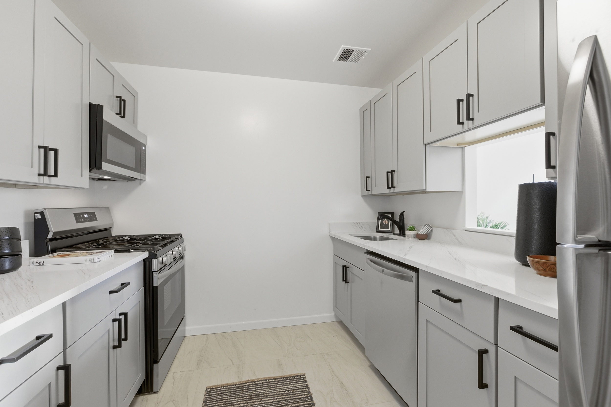 20 East 126th Street Manhattan, NY 10035 - Photo 5 of 19 a kitchen with stainless steel appliances granite countertop a sink stove and microwave