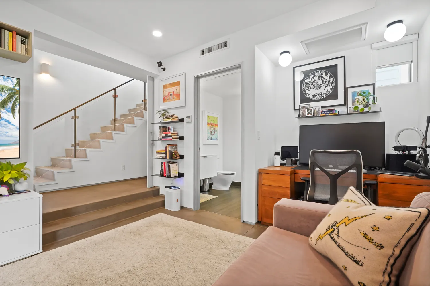 a living room with furniture and wooden floor