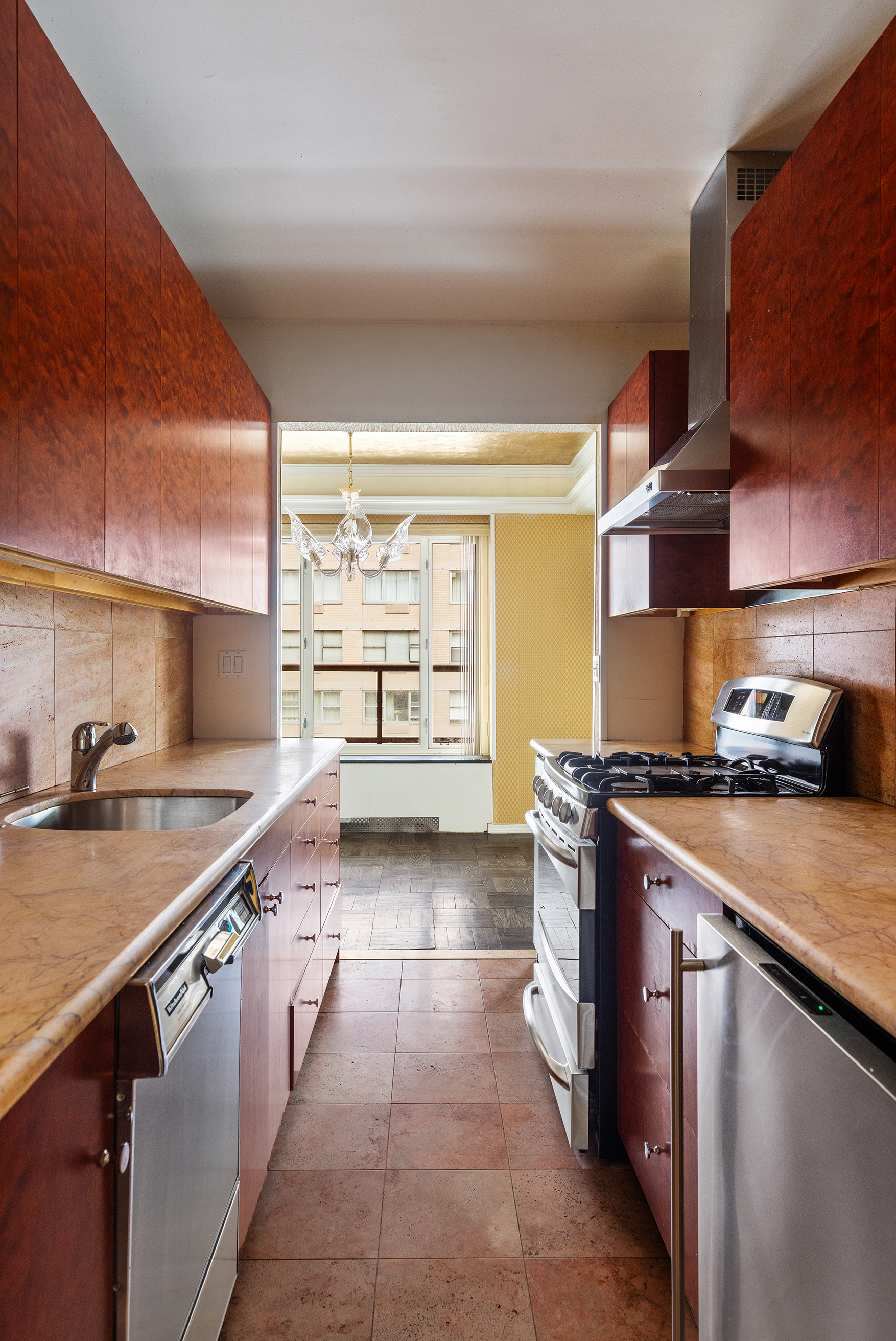 36 Sutton Place South, Unit 10B Manhattan, NY 10022 - Photo 11 of 16 a kitchen with stainless steel appliances granite countertop a sink and a stove