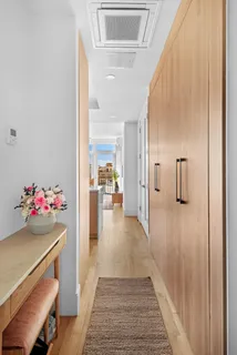 a view of a hallway view with dining room and wooden floor