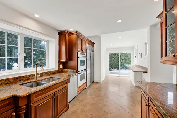 a large kitchen with a sink and large window