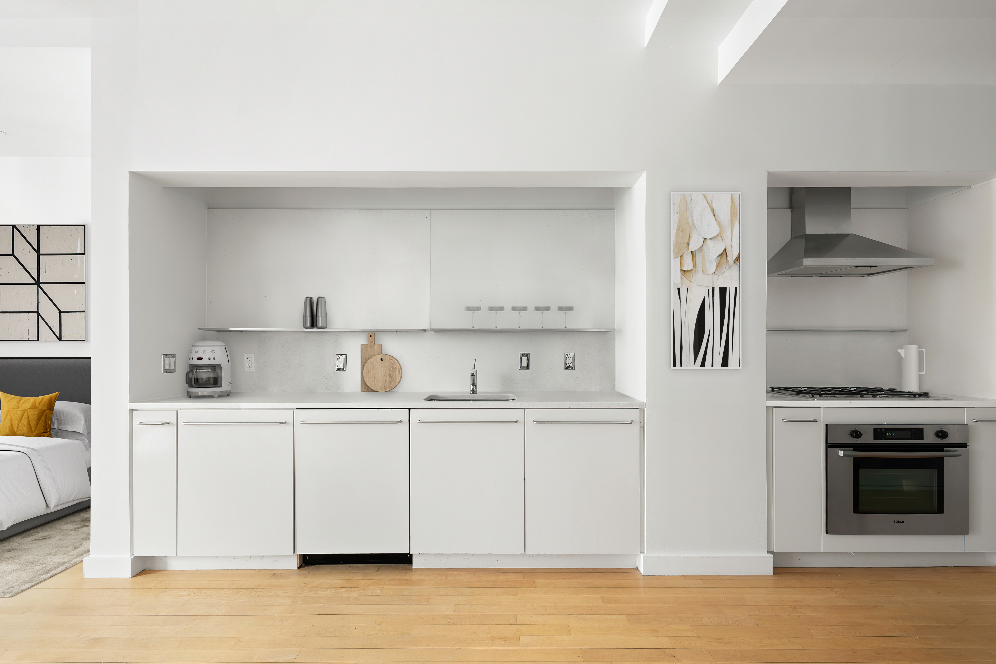 15 Broad Street, Unit 2108 Manhattan, NY 10005 - Photo 6 of 22 a kitchen with stainless steel appliances granite countertop a stove a sink and white cabinets