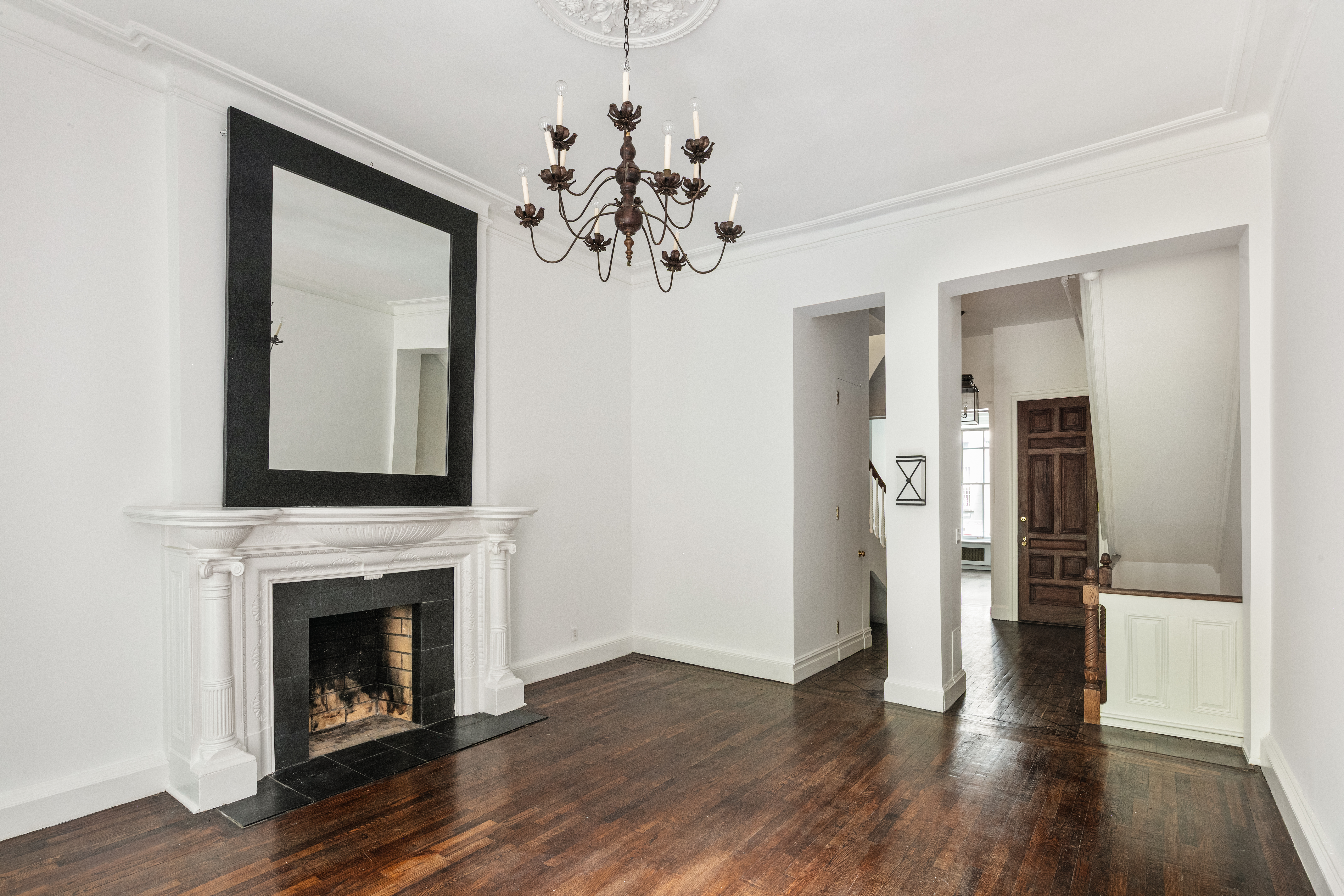 112 West 78th Street, Unit PARLOR Manhattan, NY 10024 - Photo 4 of 37 a view of a livingroom with a fireplace wooden floor and a chandelier