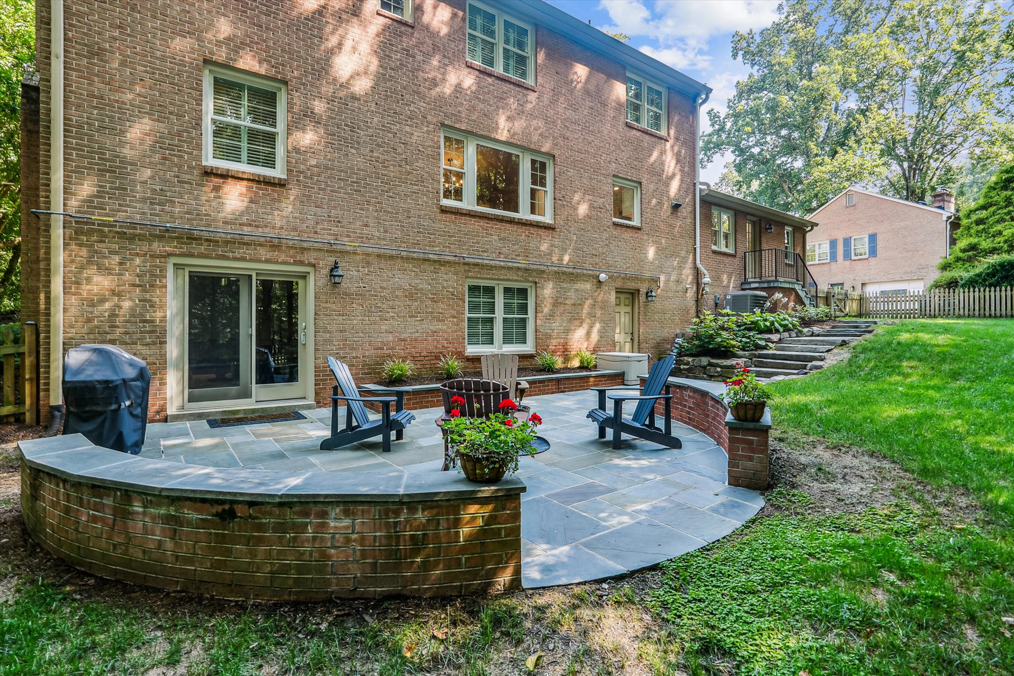 9904 Carter Road Bethesda, MD 20817 - Photo 40 of 41 a view of a house with backyard sitting area and garden
