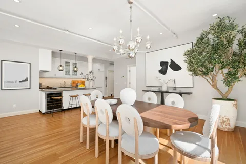a view of a dining room with furniture and wooden floor