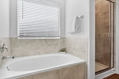 a white bath tub sitting next to a white sink