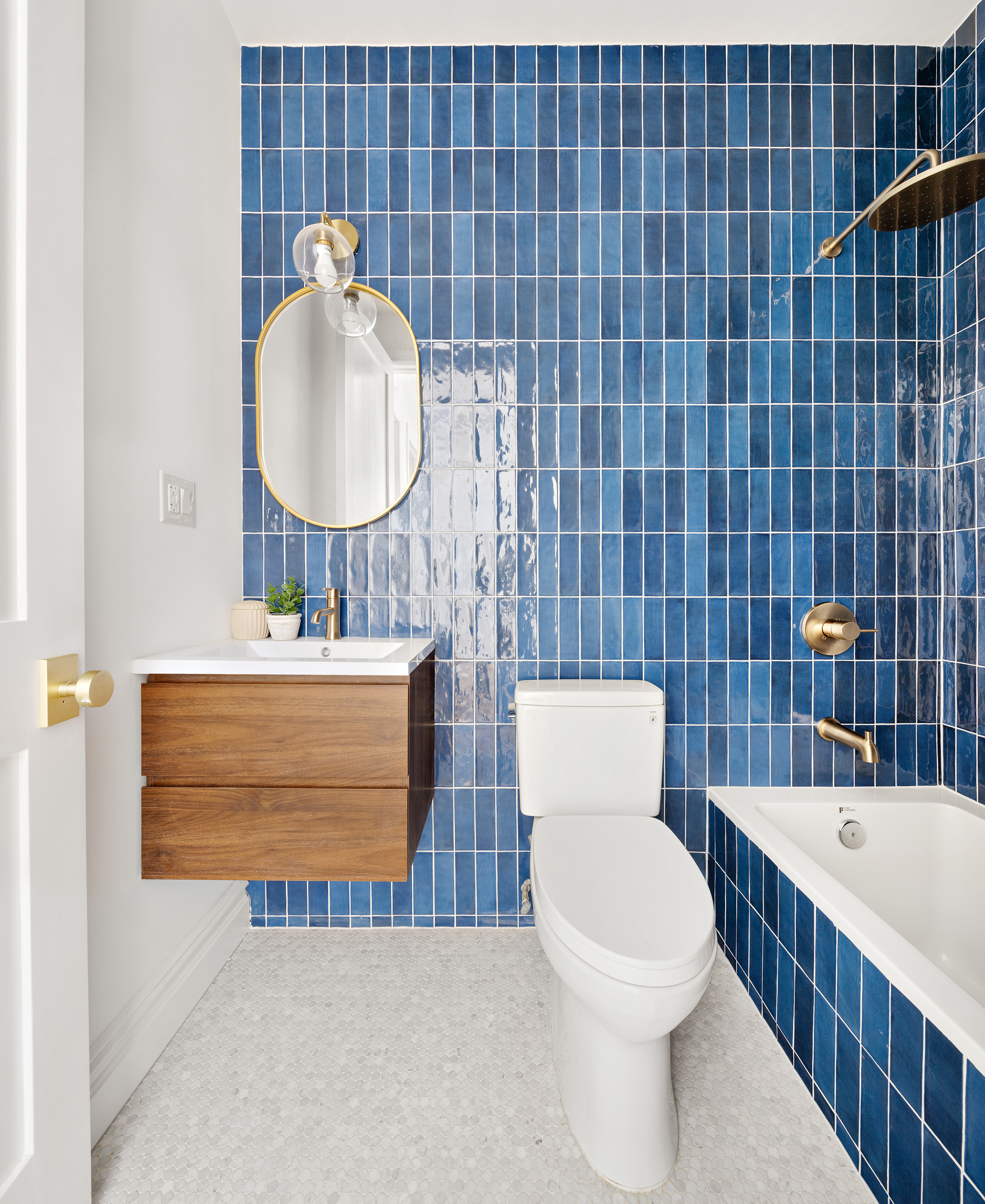 557 Saint Marks Avenue Brooklyn, NY 11216 - Photo 11 of 13 a bathroom with a sink a toilet and mirror