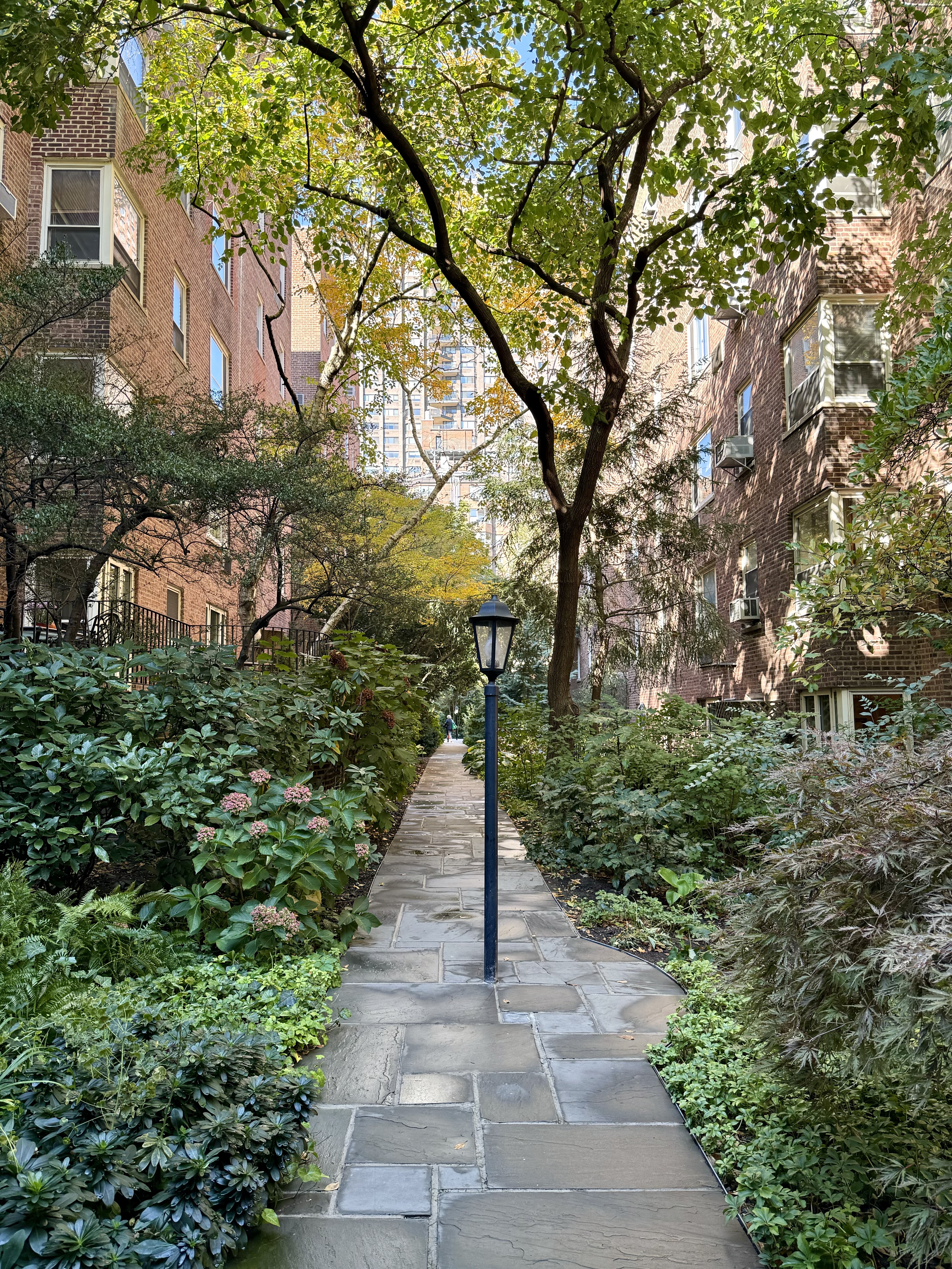 525 East 89th Street, Unit 2L Manhattan, NY 10128 - Photo 12 of 13 a view of a pathway with a tree