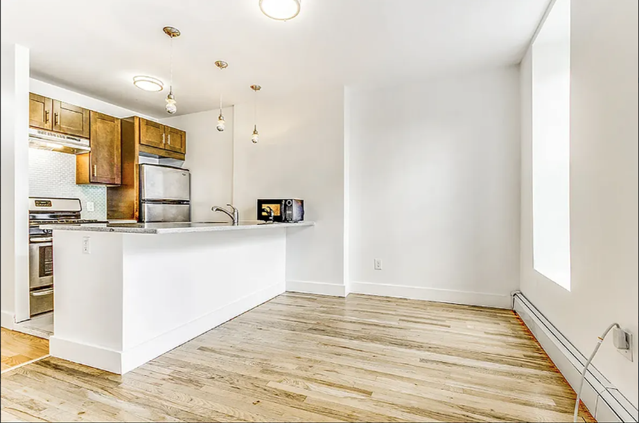406 Monroe Street, Unit 3 Brooklyn, NY 11221 - Photo 3 of 11 a view of kitchen with wooden floor