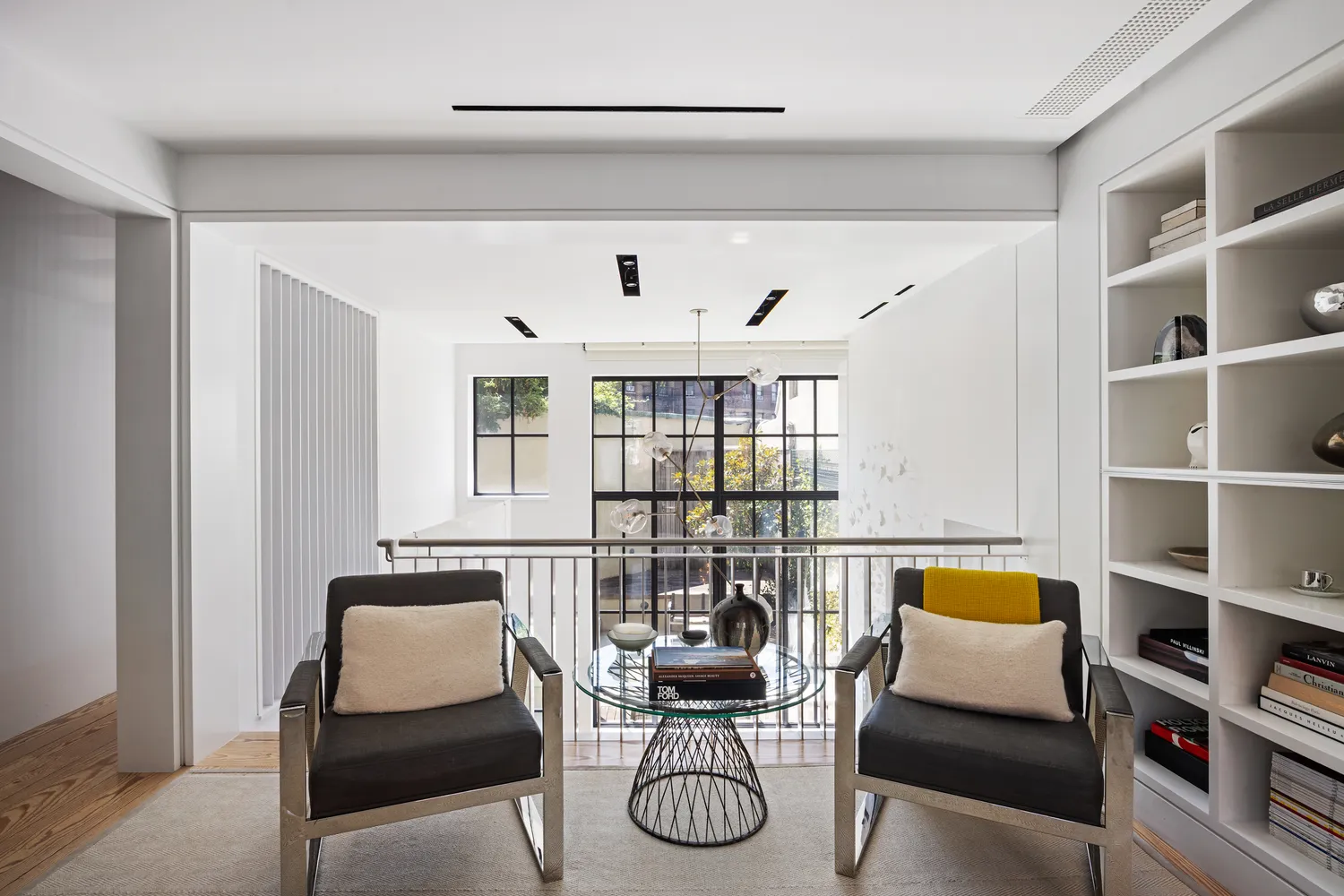 a living room with furniture a lamp and a bookshelf