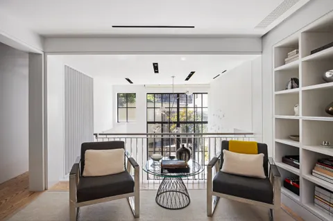 a living room with furniture a lamp and a bookshelf