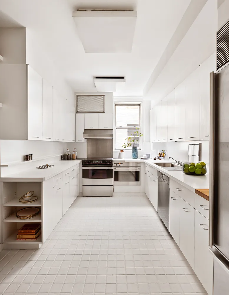a kitchen with stainless steel appliances a stove sink and cabinets