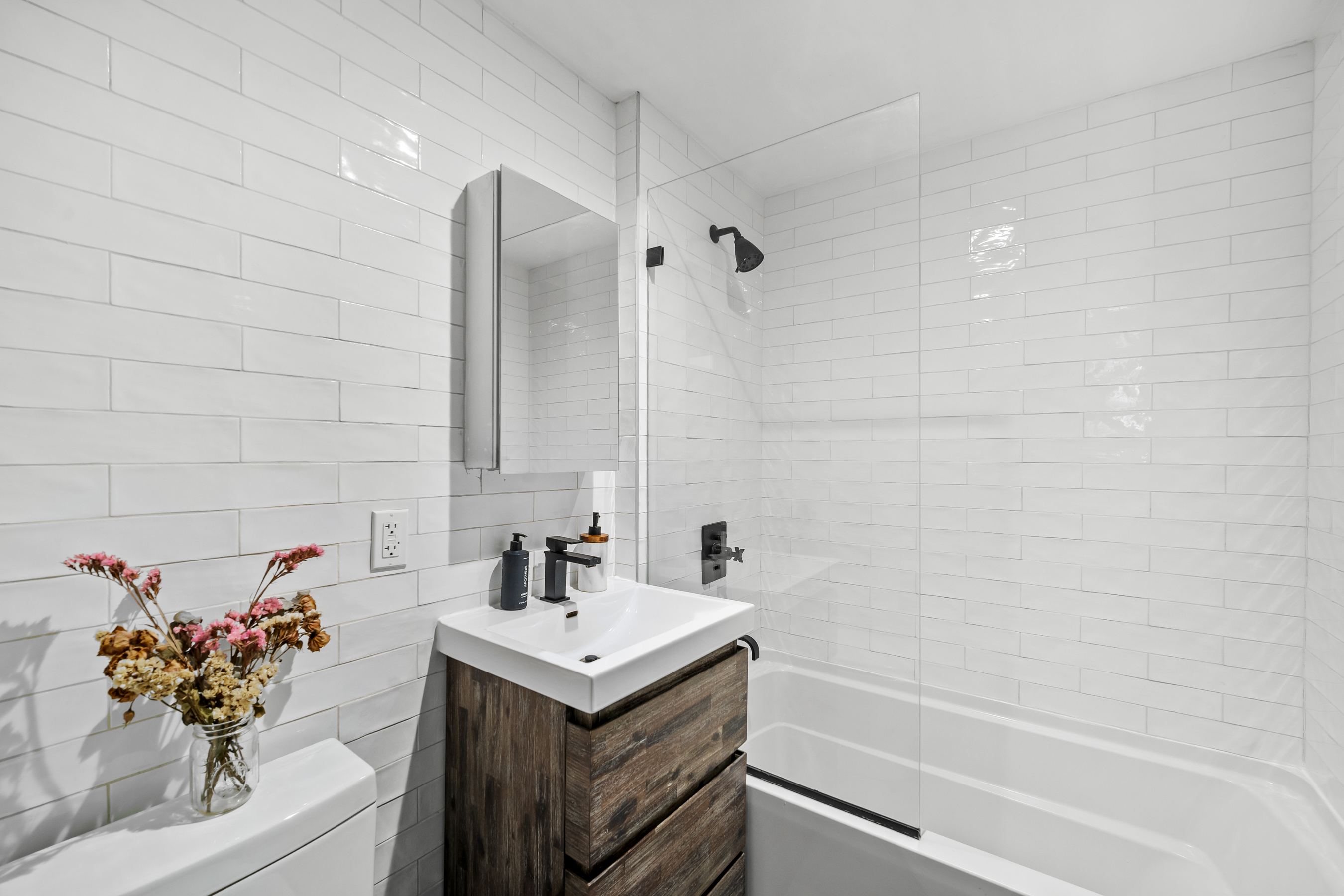 158 15th Street, Unit 1B Brooklyn, NY 11215 - Photo 13 of 14 a bathroom with a sink toilet and shower