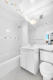 a bathroom with a granite countertop sink a toilet and bathtub