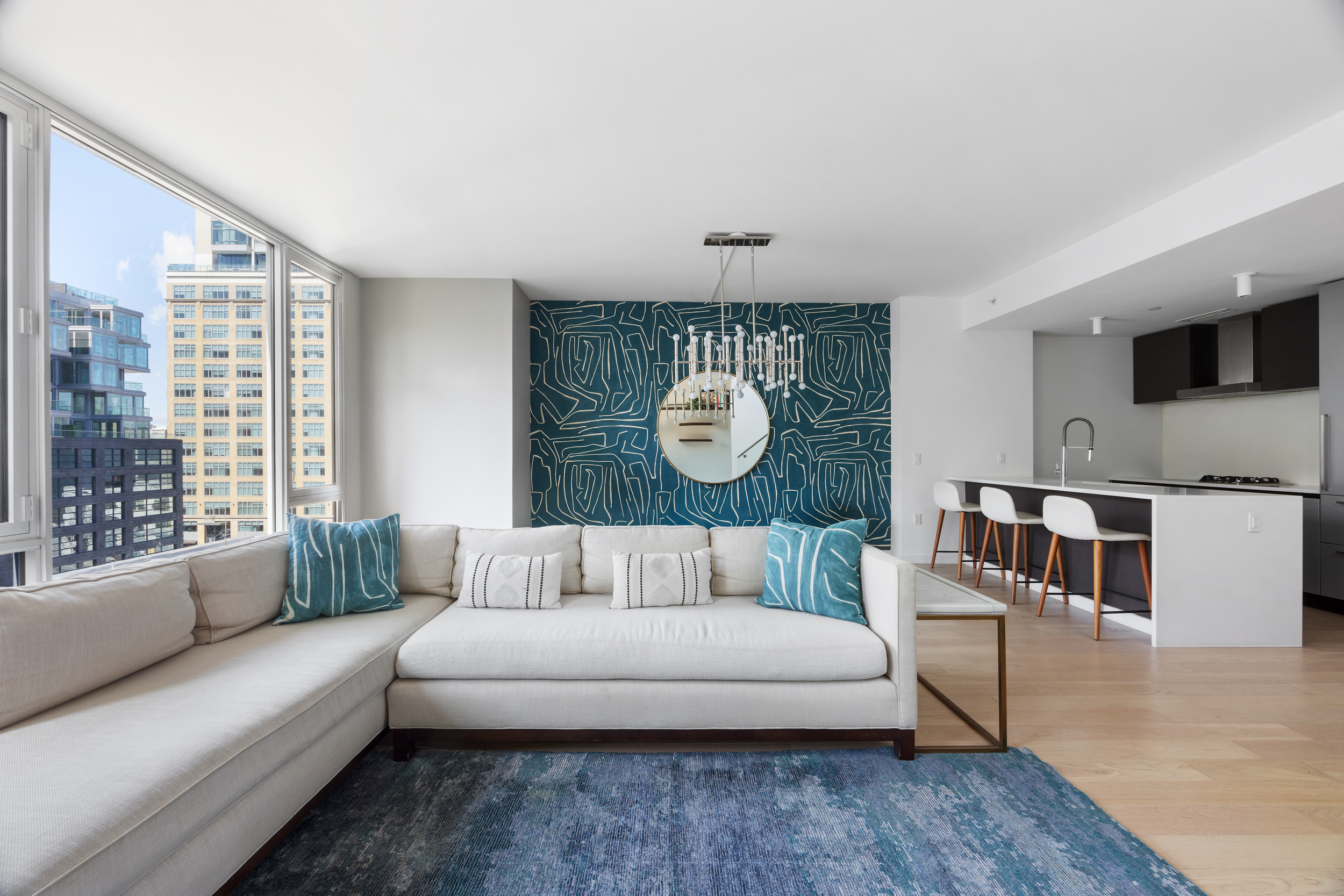 540 West 49th Street, Unit PH1N Manhattan, NY 10019 - Photo 4 of 18 a living room with furniture and a large window