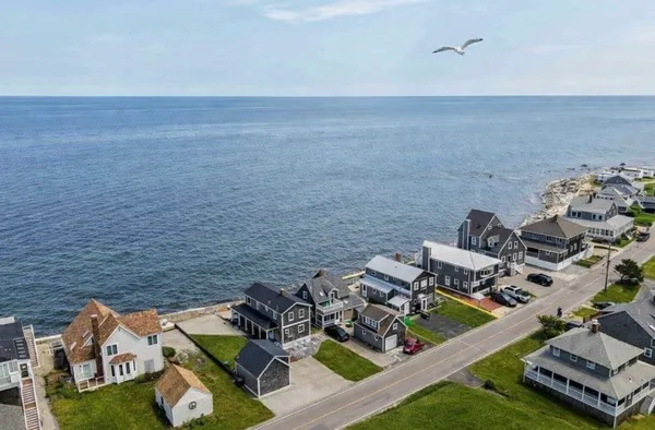 a view of a ocean with lawn chairs