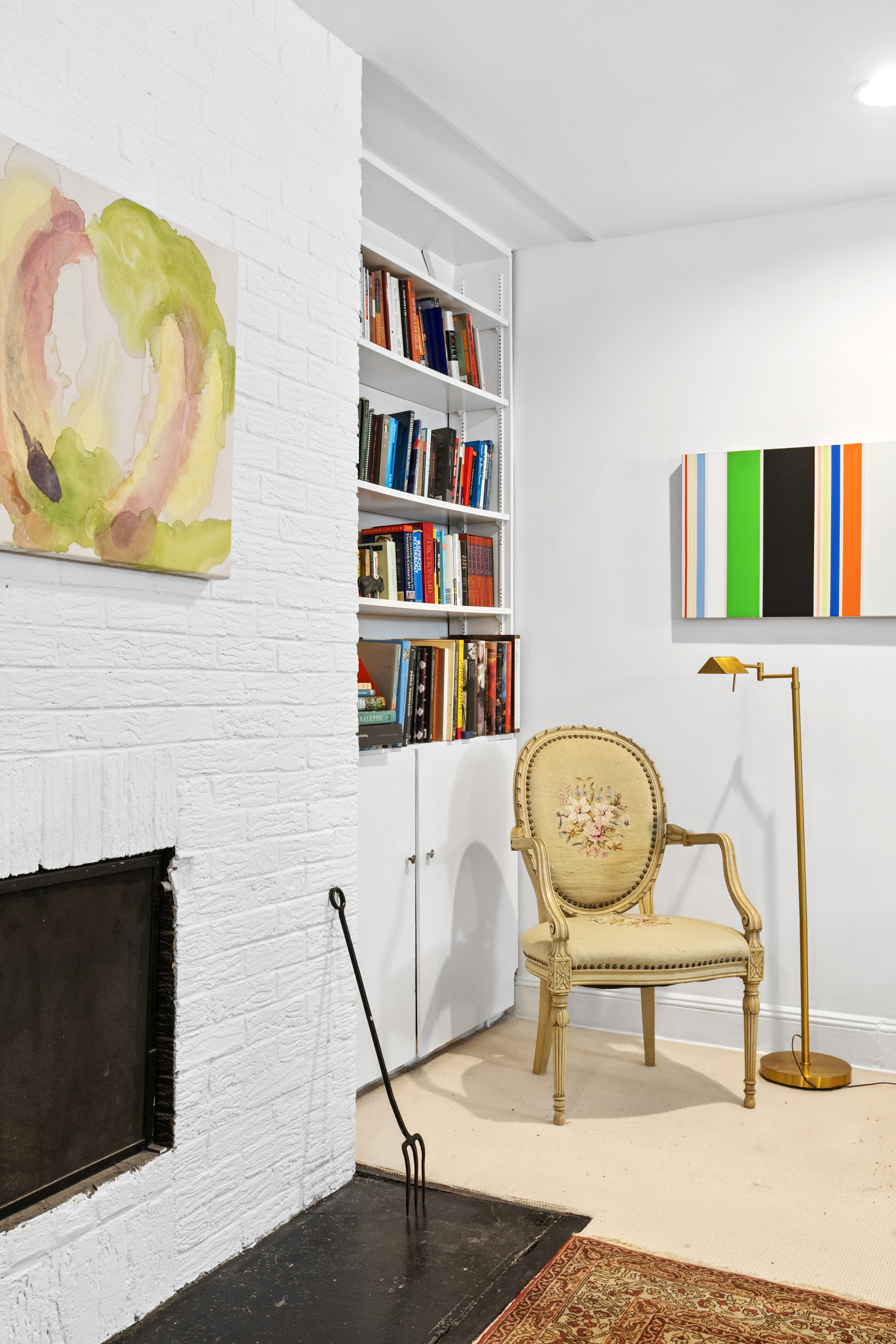 50 East 83rd Street, Unit 1R Manhattan, NY 10028 - Photo 6 of 12 a living room with fireplace furniture and a flat screen tv