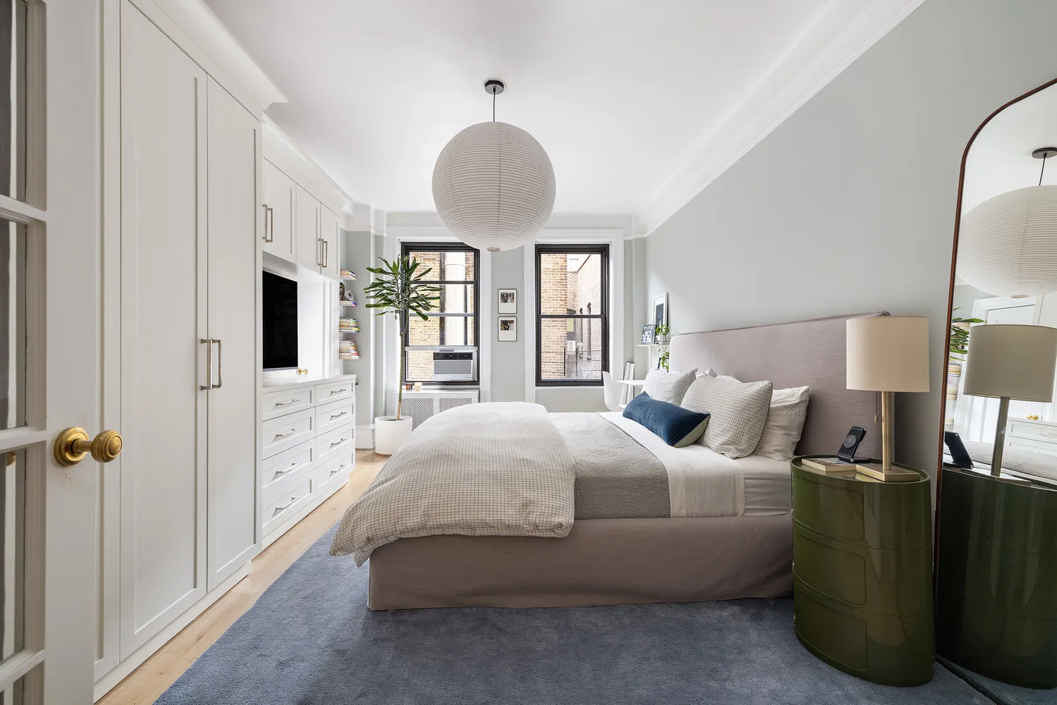 a bedroom with bed and a chandelier