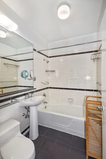 a bathroom with a shower a bathtub and a shower