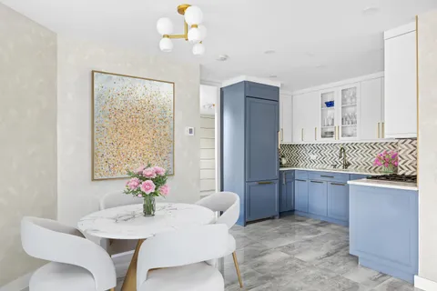 a dining room with furniture and chandelier