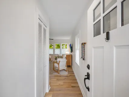 a view of a backyard with wooden fence and large trees
