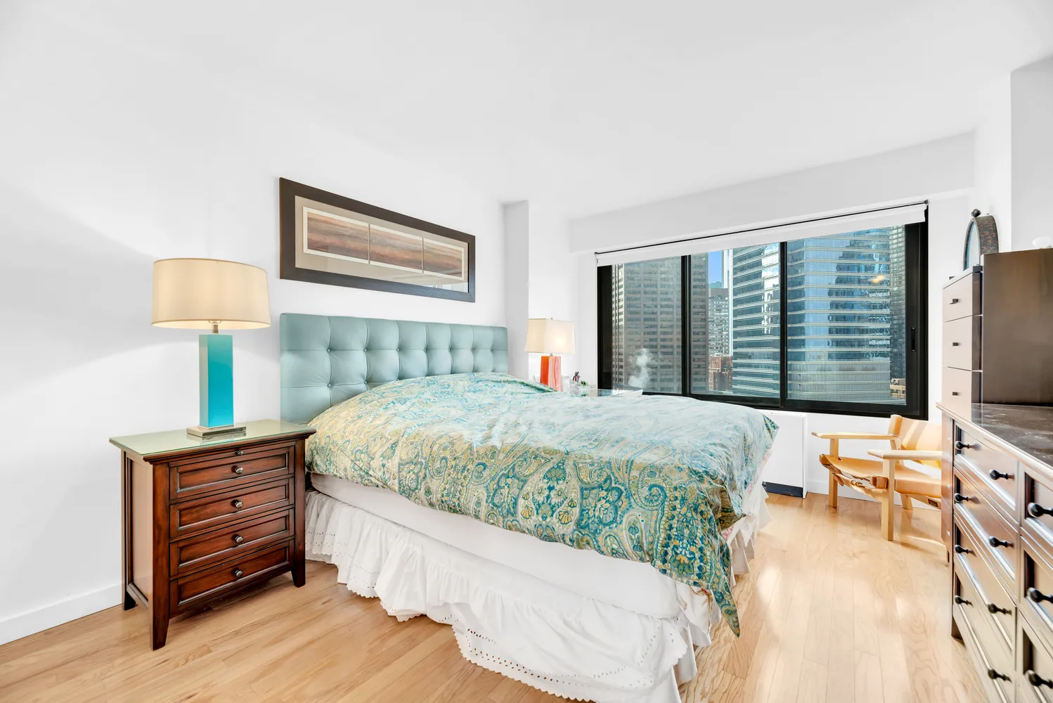 a bed sitting in a bedroom next to a window