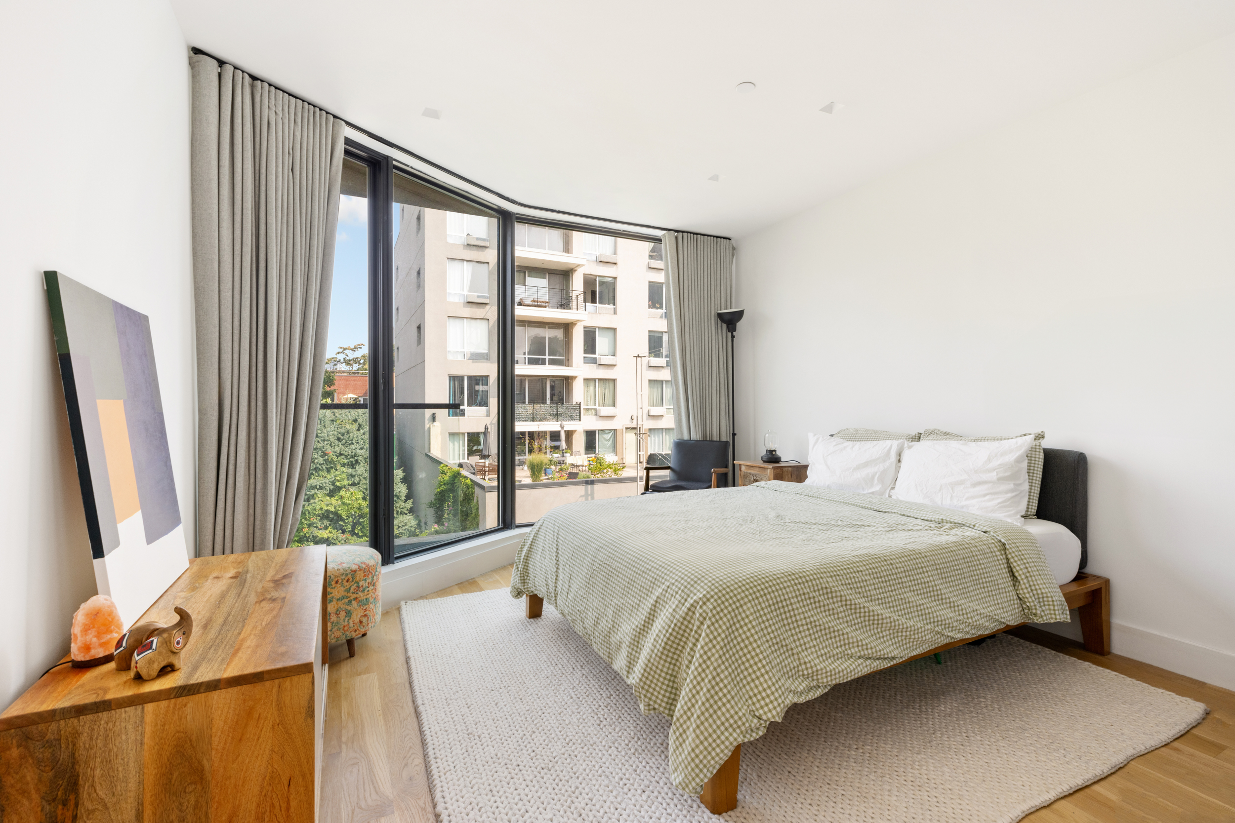 205 Freeman Street, Unit 3 Brooklyn, NY 11222 - Photo 4 of 9 a bedroom with a large bed and a large window