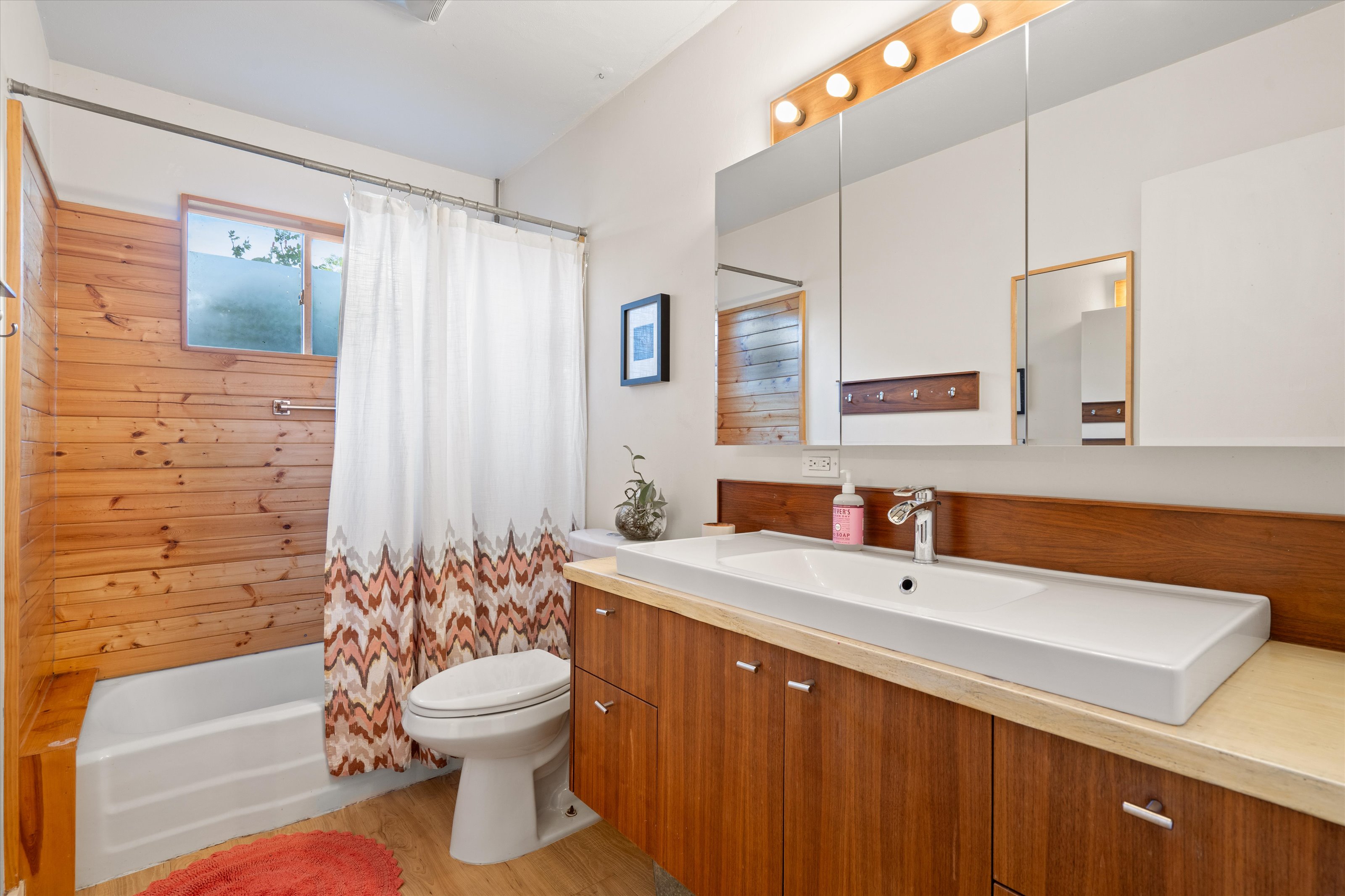 4614 Jinx Avenue Austin, TX 78745 - Photo 18 of 40 a bathroom with a sink a toilet and shower
