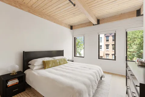 a bedroom with a large bed and a window